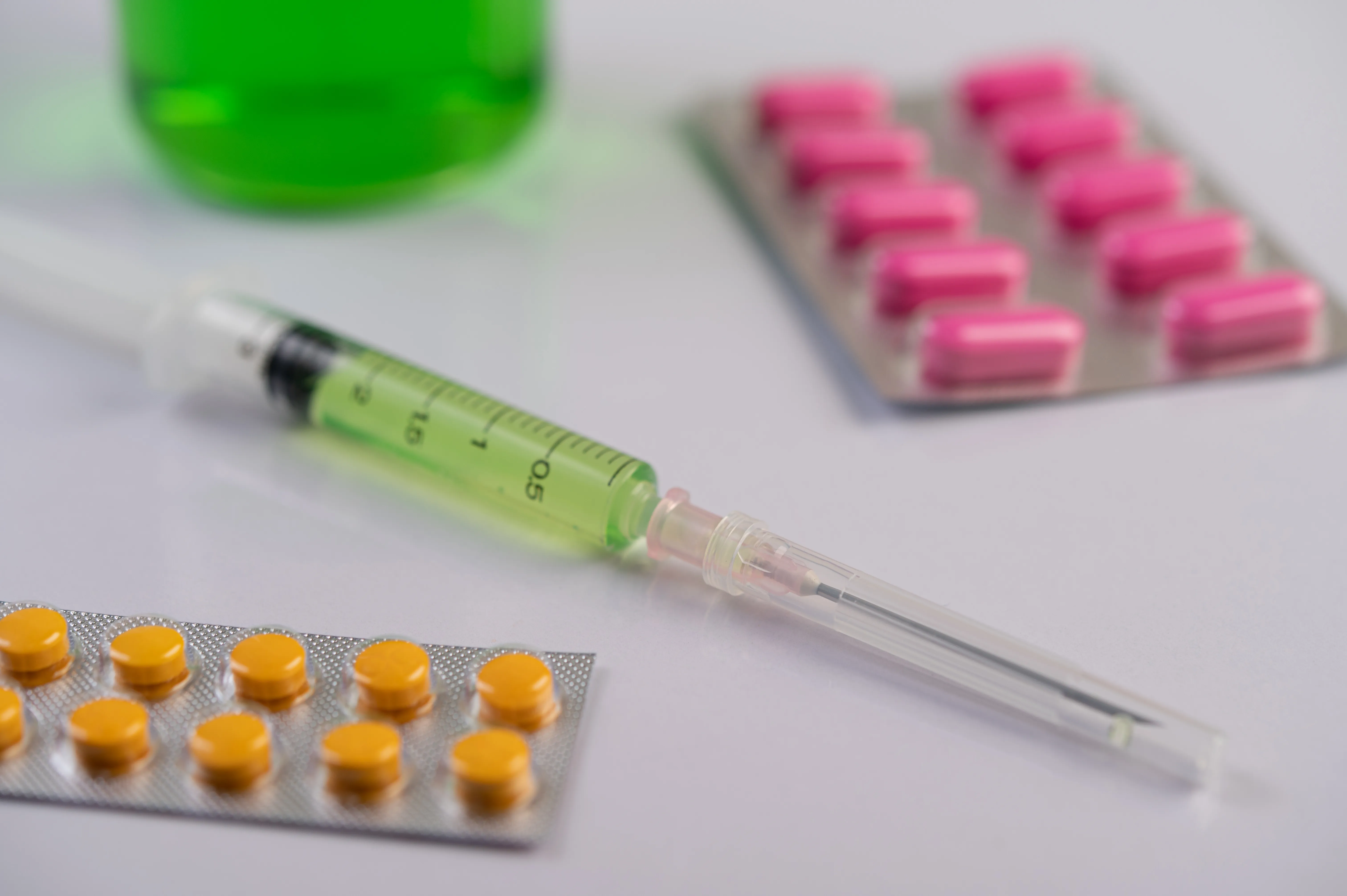 gloved hand holding test tube by river