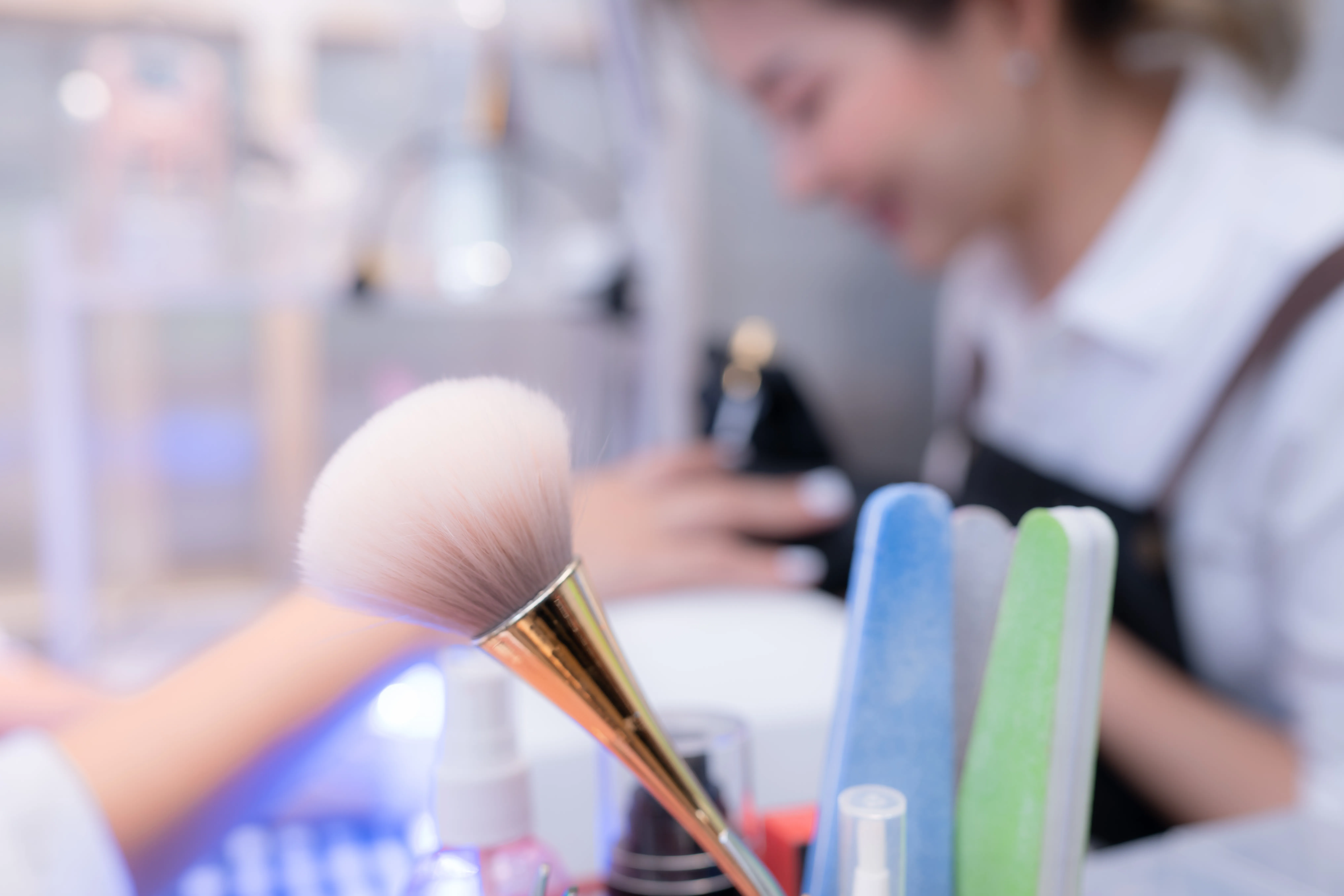 gloved hand holding test tube by river