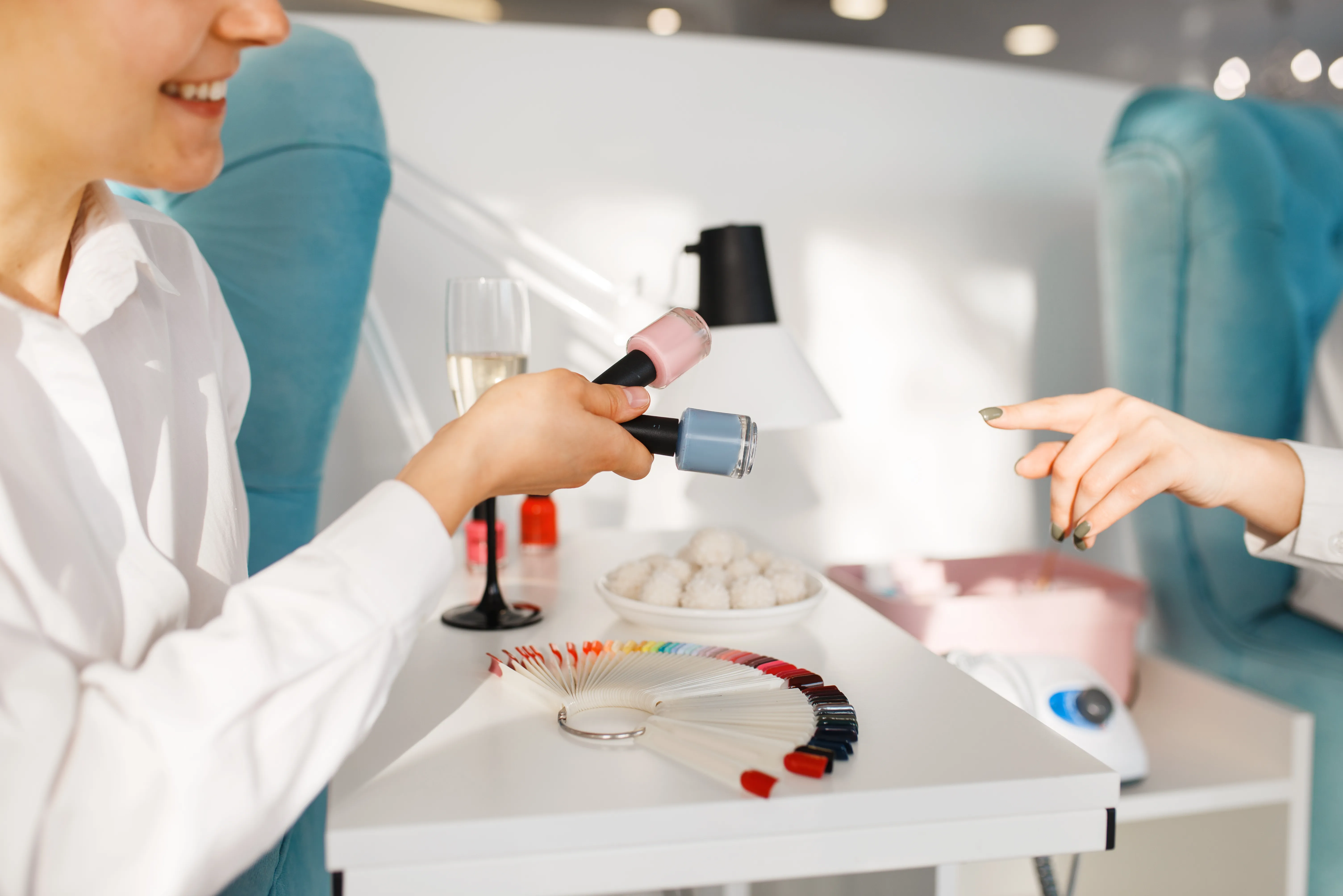gloved hand holding test tube by river