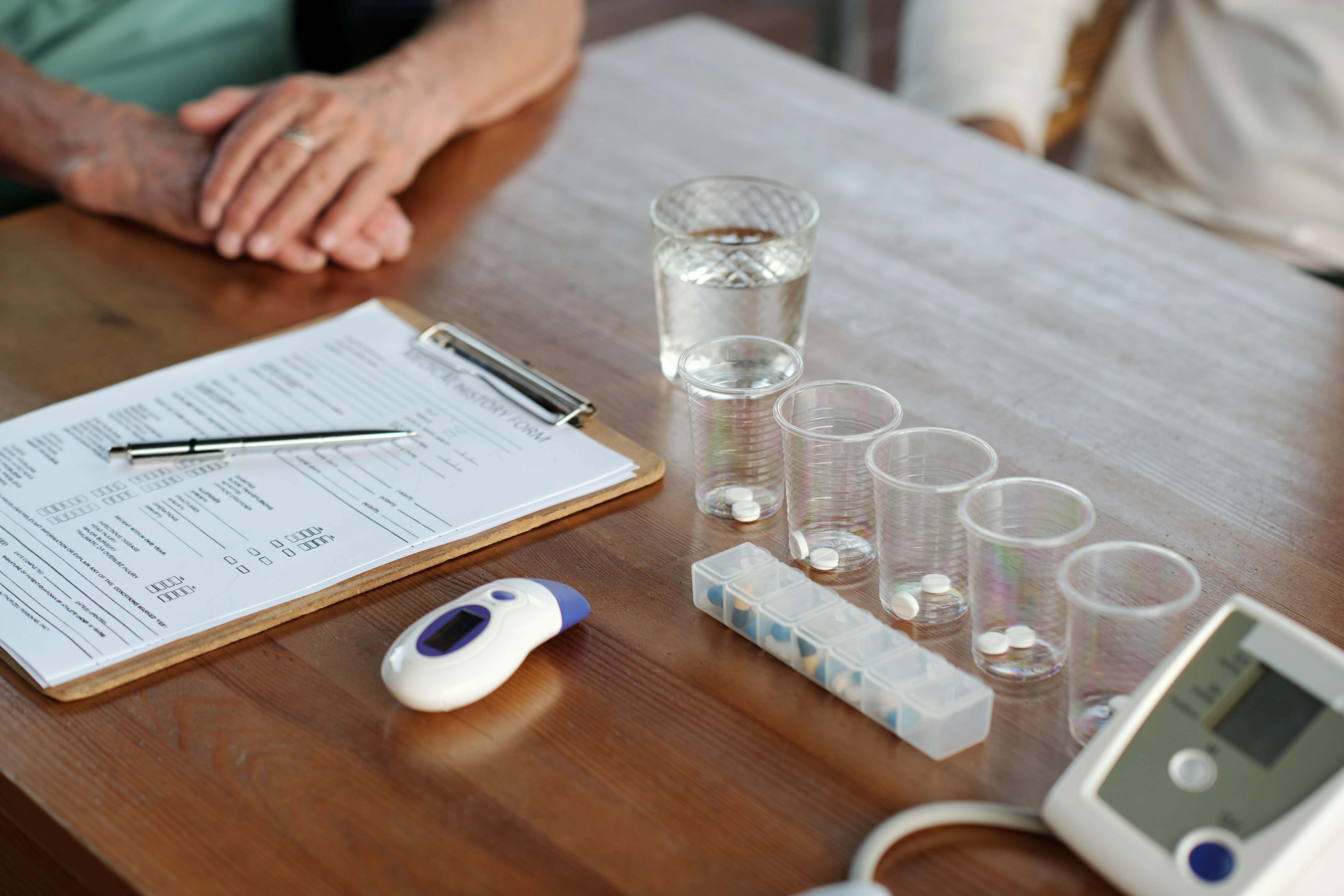 gloved hand holding test tube by river